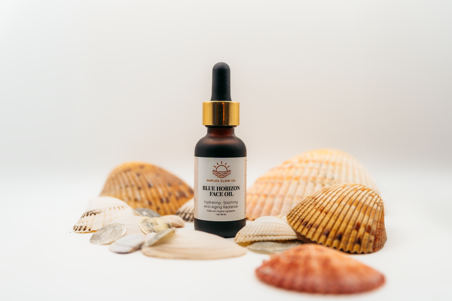 Blue Horicon Face Oil surrounded by shells